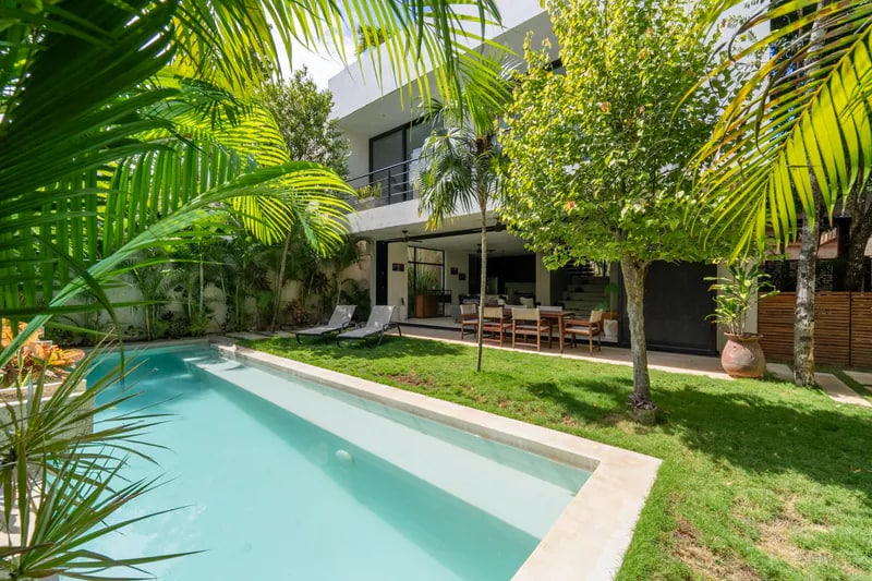 Modern vacation home with a private pool surrounded by tropical landscaping