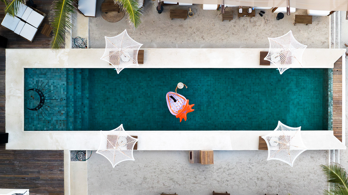 Overhead photograph of the beach-club pool and surrounding loungers — Balabambas Beach Club
