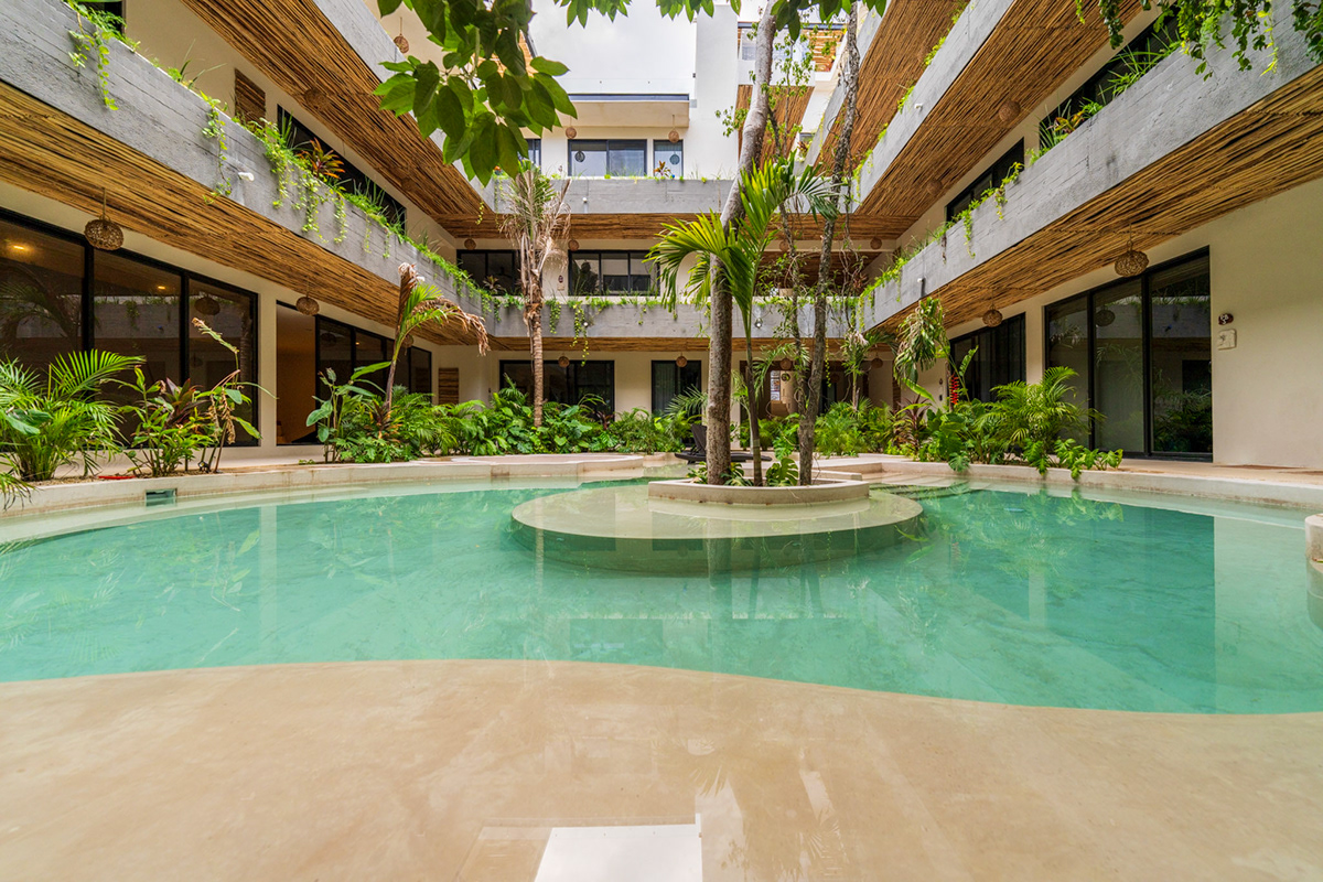 Courtyard swimming pool beneath planted balconies — Casa Noil 26