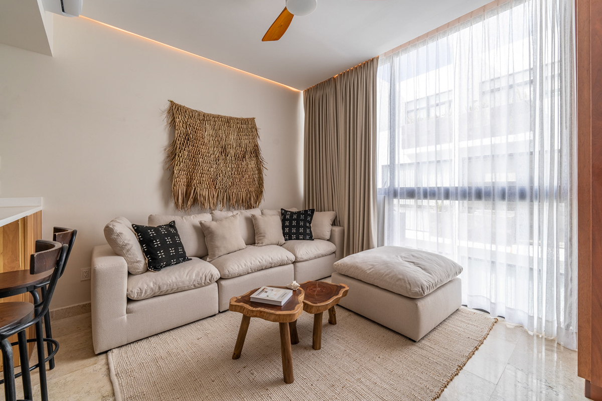 Living room with a sectional sofa and sheer floor-to-ceiling curtains — Elena