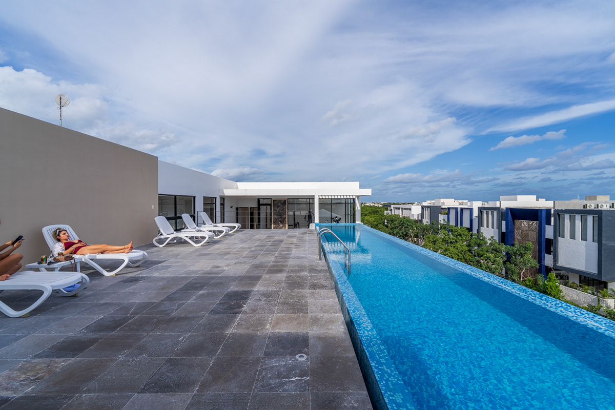 Rooftop pool with loungers and views across the surrounding buildings — Elena