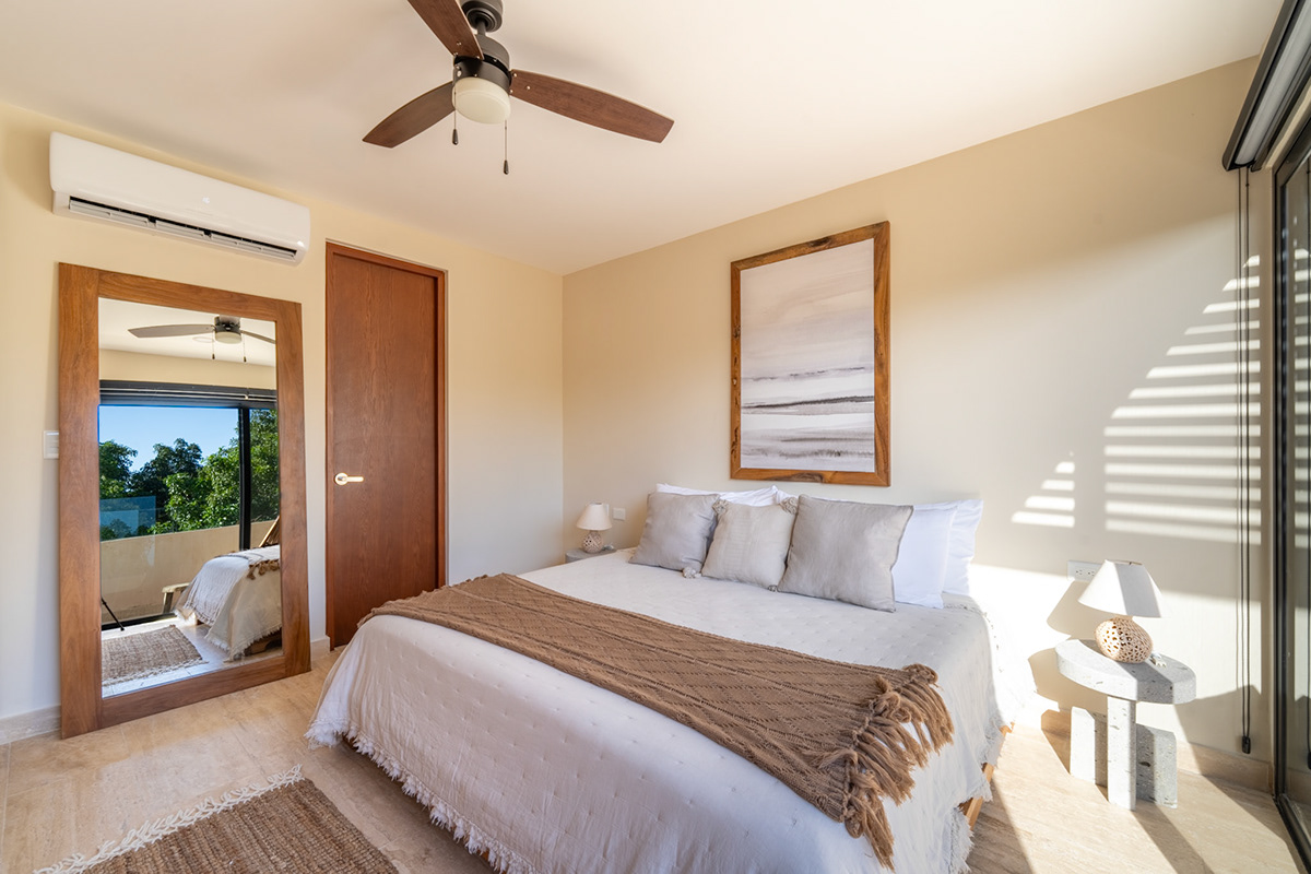 Sunlit bedroom with warm neutral colors and a terrace door — Paramar