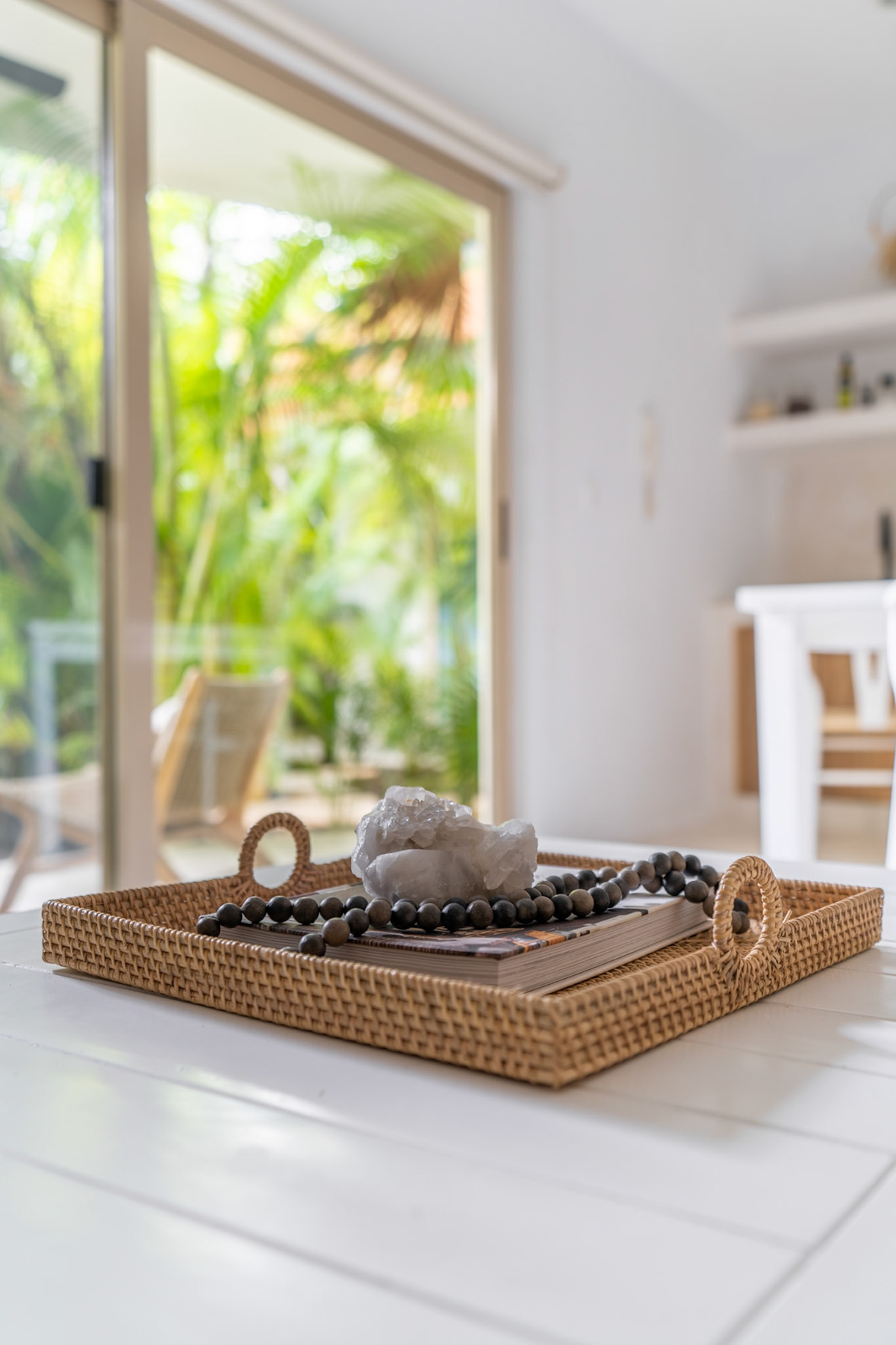 Coffee-table detail beside the garden-facing living-room windows — Real Zama