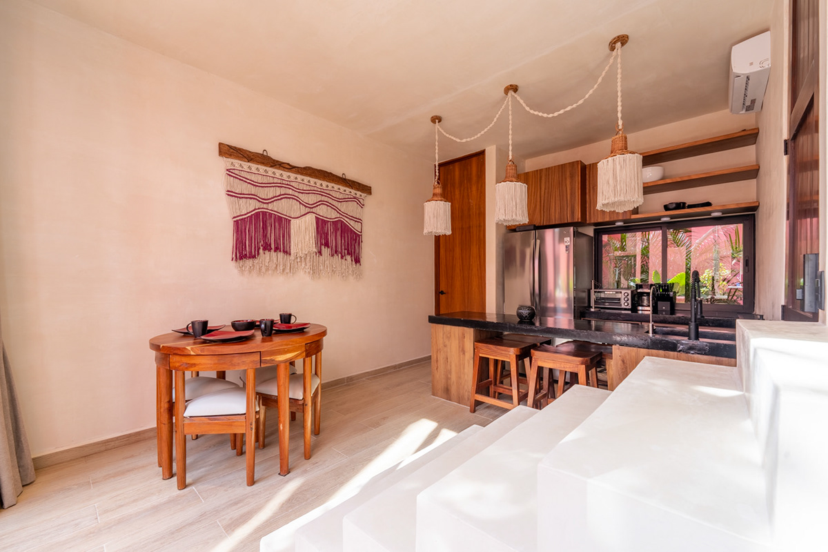 Open kitchen and dining area with timber cabinetry and a white staircase — Tulix 8